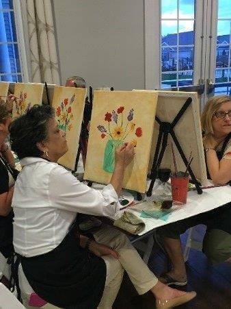 People painting at a community event from Traditions of america