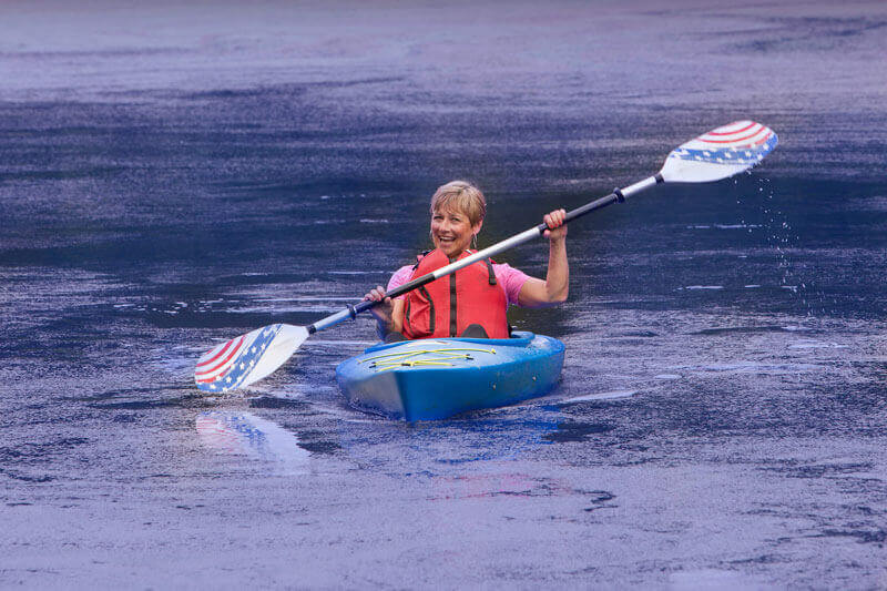 Active adult woman kayaking