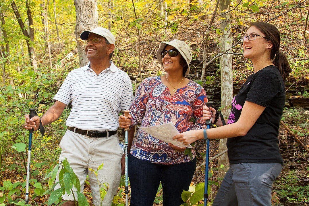 People standing in the woods looking around