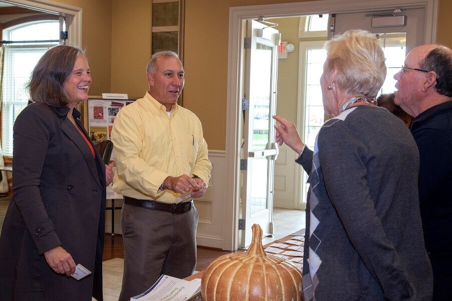 People talking in the lobby of the silver spring clubhouse from Traditions of america