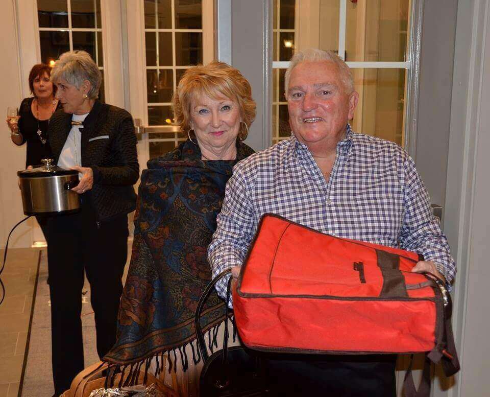 People bringing food to a potluck in the traditions of America clubhouse