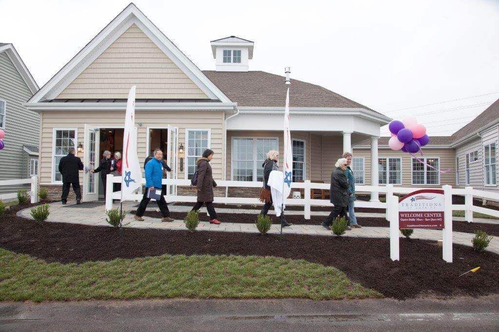 People walking out of a Traditions of America open house