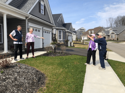 Neighbors greeting each other at their new Traditions of america house