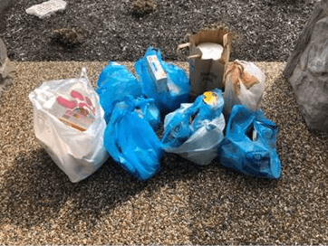 shopping bags on the ground outside of a home