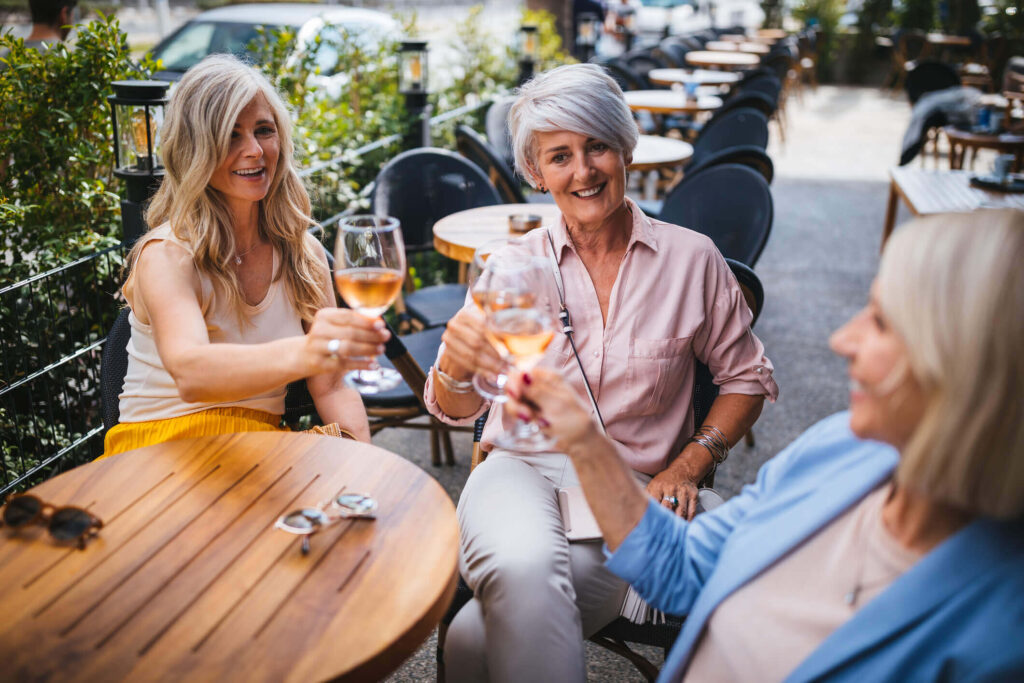 Three women enjoying glasses of wine outside in richmond virginia