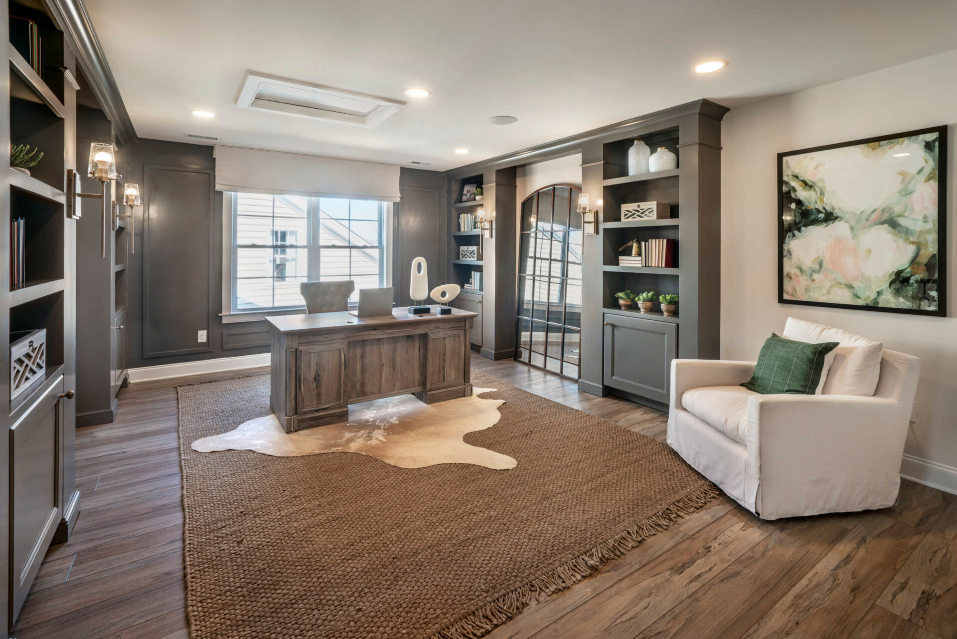 Large Office room with build in shelves and desk in the middle from traditions of America