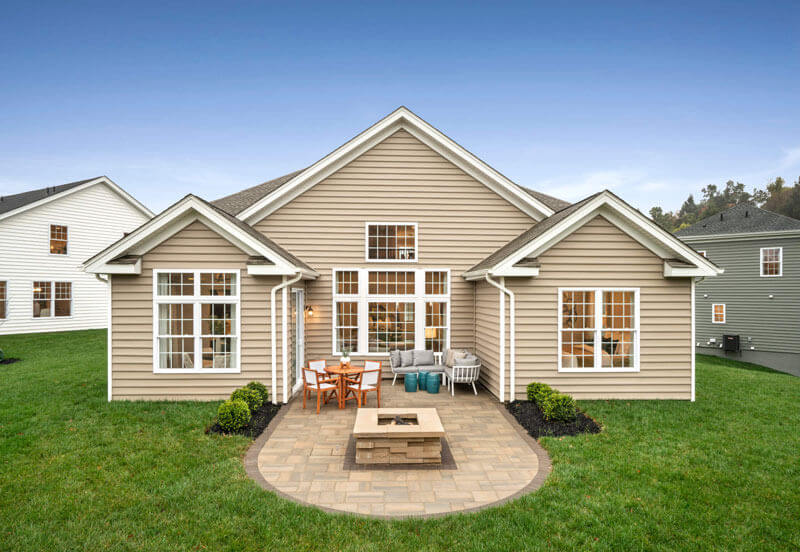Rear elevation of a traditions of america home with a patio