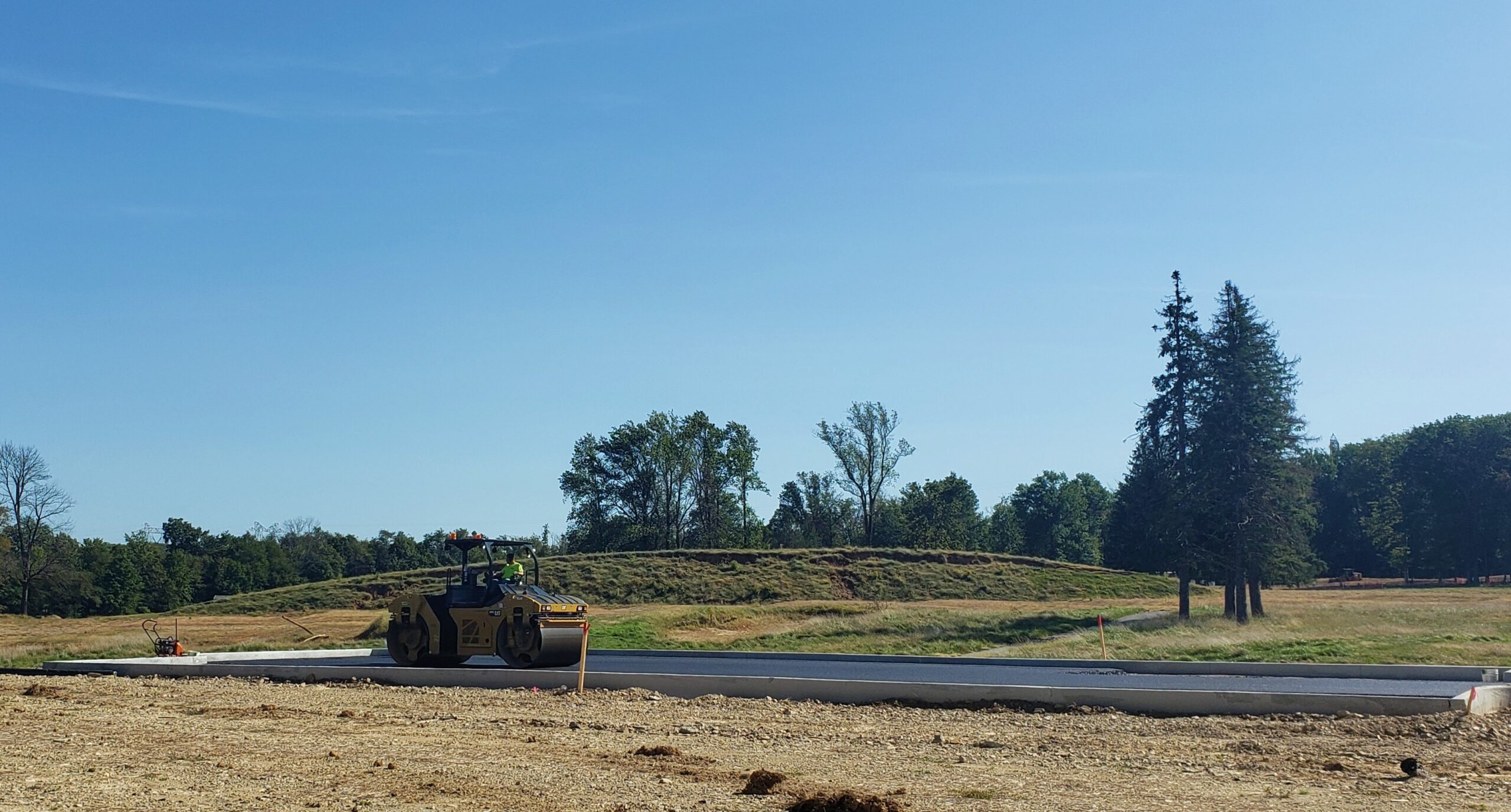 Person paving concrete on a Traditions of America Homesite