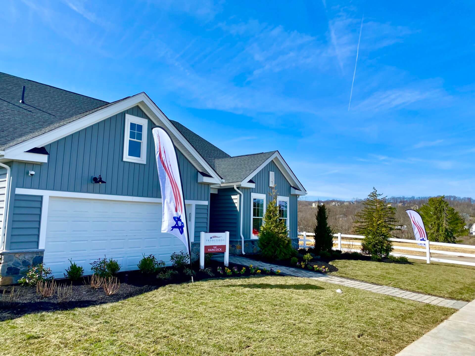Front elevation of a blue home from Traditions of America