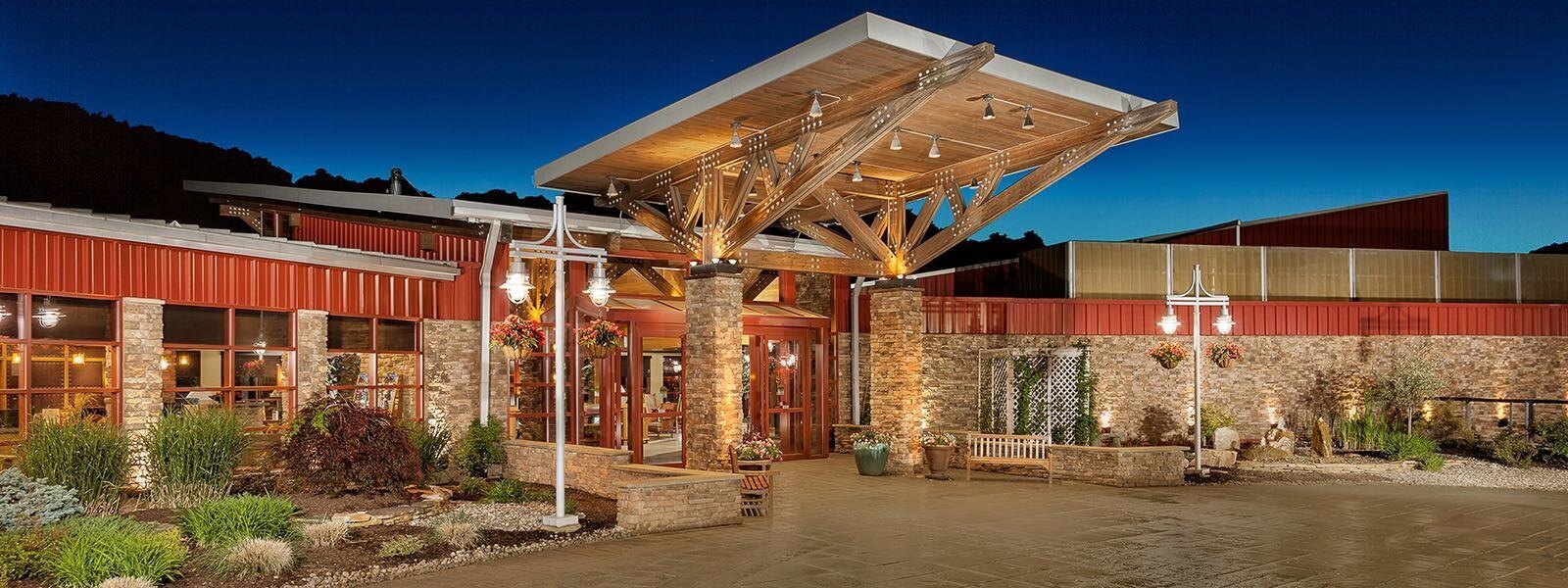 Front of a stone building with red accents