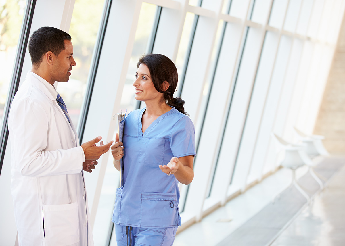 Doctor and Nurse in Hospital Hallway