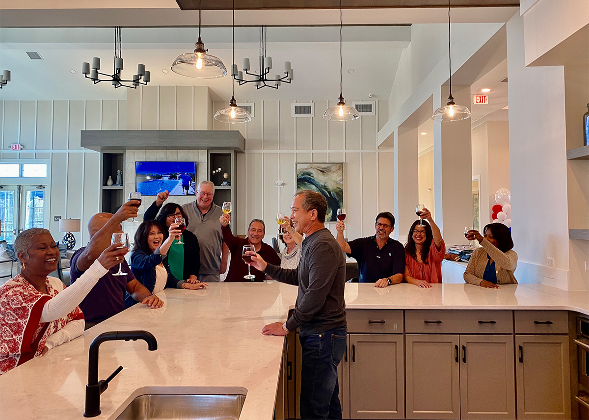 People Cheersing at a Counter In a Traditions of America Clubhouse