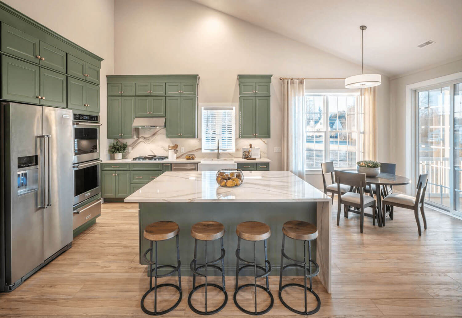 Kitchen with green cabinets and center island from Traditions of America