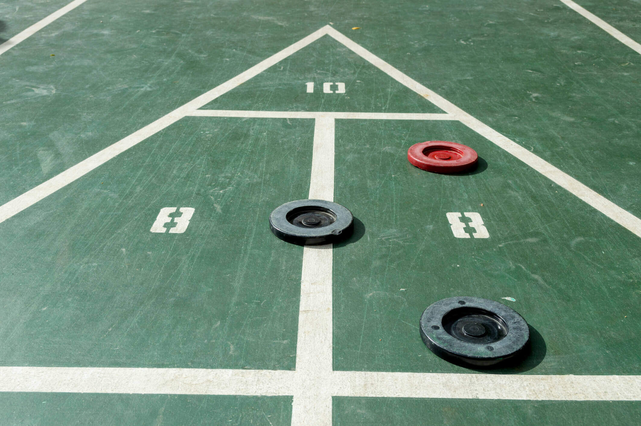 Shuffle board court with three discs 