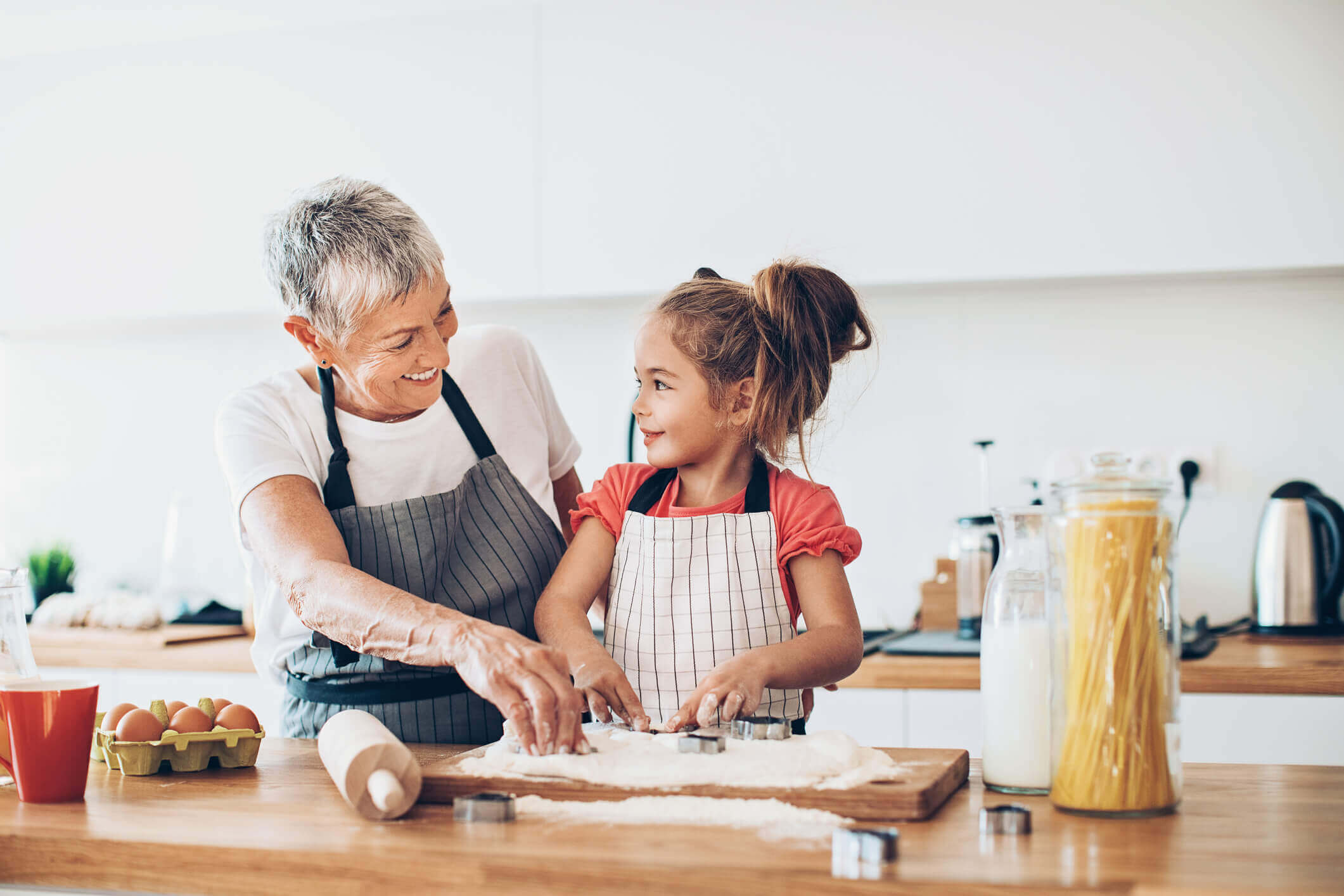grandma and granddaughter cooking together