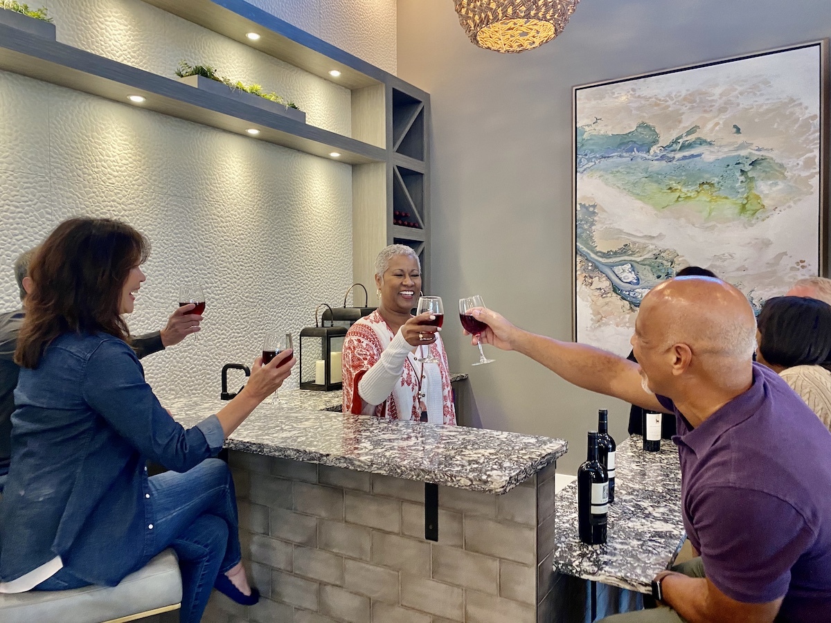 People Cheersing at a Counter In a Traditions of America Clubhouse